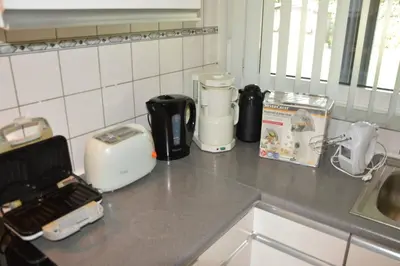 a kitchen counter with various appliances on a counter top at Charming Belgian Getaway, vakantiewoning in Oudsbergen - 3 Bedrooms Garden in Oudsbergen