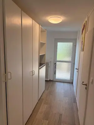 an empty hallway with white cabinets and a window at Appart de Lux , 3 borders , free parking , in La Calamine