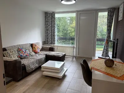 a living room with a couch and a table at Appart de Lux , 3 borders , free parking , in La Calamine