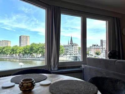 a room with a large window with a view of the river at Le 180 escapade face à la Meuse in Liège