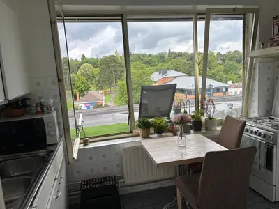 a kitchen with a table and a large window at Central peak of Embourg Apartment in Chaudfontaine