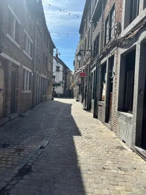 an empty street in an old town with buildings at Petite maison typique en Outremeuse - 2 à 4 personnes in Liège
