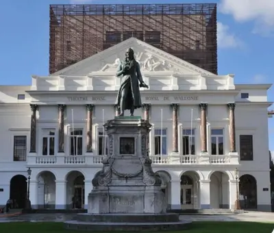 a statue of a woman in front of a white building at AppartCosy in Liège