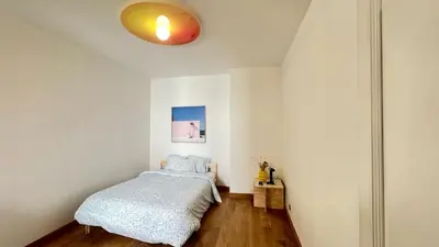 a bedroom with a bed and a light on the ceiling at Cozy Neuvice apartment in Liège