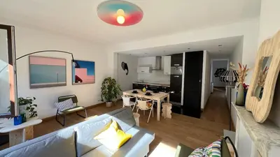 a living room with a couch and a table at Cozy Neuvice apartment in Liège