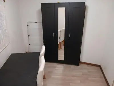 a room with a black door and a mirror at Petit appartement RDC in Liège