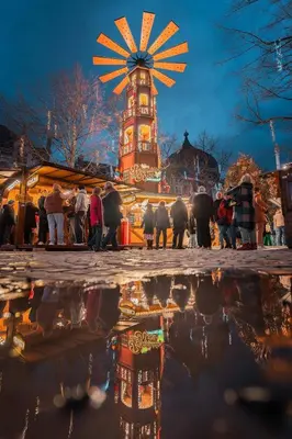 a reflection of a clock tower in a puddle of water at 102 Cozy Neuvice in Liège