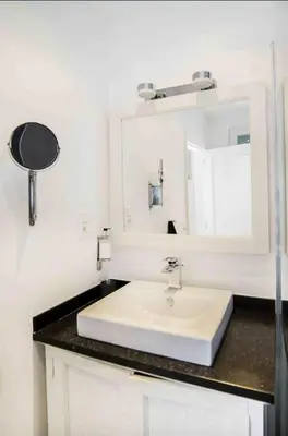a bathroom with a white sink and a mirror at 102 Cozy Neuvice in Liège