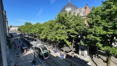 a bus is parked at a bus stop on a street at 202 Le Coeur de Liege in Liège