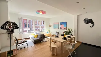 a living room with a table and a couch at 202 Le Coeur de Liege in Liège
