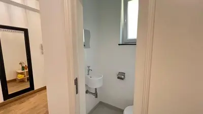 a bathroom with a toilet and a sink at 201 Loft Lumineux en Hyper-Centre in Liège