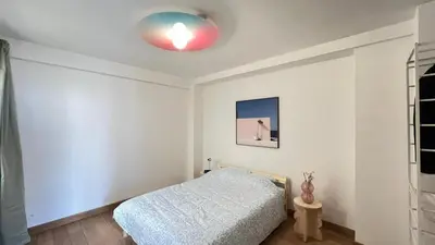 a bedroom with a bed and a red light on the ceiling at 201 Loft Lumineux en Hyper-Centre in Liège