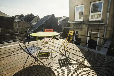 a table and chairs on top of a balcony at 302 Le Spot Neuvice in Liège