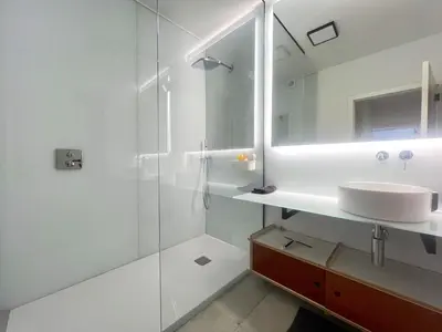 a white bathroom with a sink and a shower at 303 Loft design Cathéderale in Liège