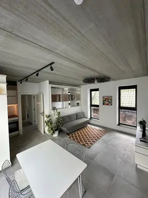 a living room with a white table and chairs at 303 Loft design Cathéderale in Liège