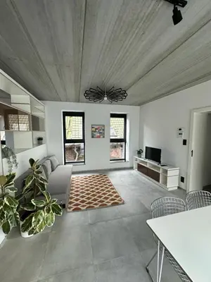 a living room with a couch and a table at 303 Loft design Cathéderale in Liège