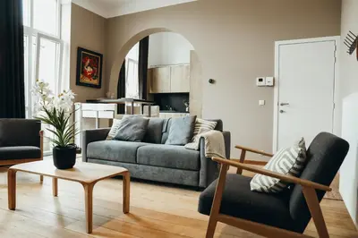a living room with a couch and a table at Liège Centre-ville by WelcHome in Liège