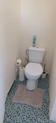 a bathroom with a white toilet in a room at CHAMBRE Privée in Seraing