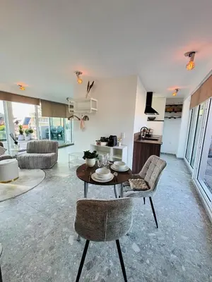 a living room with a table and chairs at GG'S studio in Hasselt