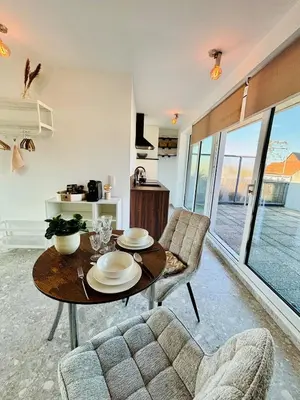 a living room with a table and two chairs at GG'S studio in Hasselt