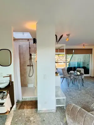 a living room with a shower and a table at GG'S studio in Hasselt