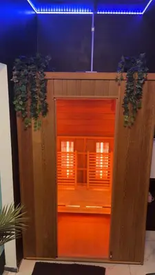 a wooden door with two plants on top of it at La suite 7 Sauna et jacuzi in Seraing
