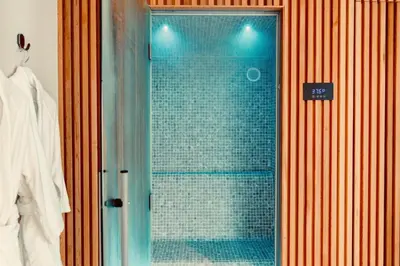 a shower with a glass door in a bathroom at La Suite Kalys in Thimister