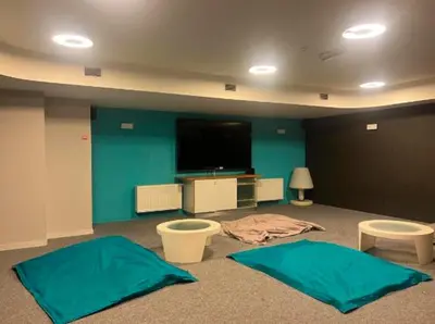 a room with two blue mats on the floor and a flat screen tv at Business trip - Sauna, gym, rooftop in Liège