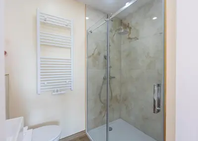 a bathroom with a glass shower with a toilet at Appartement romantique de luxe à Liège Chambre, salon SDB privée 2e étage in Liège