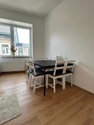 a dining room with a black table and chairs at Appartement romantique de luxe à Liège Chambre, salon SDB privée 2e étage in Liège