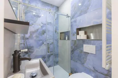 a bathroom with a shower with a sink and a toilet at Chambre de luxe RIO a Liège Sale de bain privée check in autonome cuisine partagée in Liège