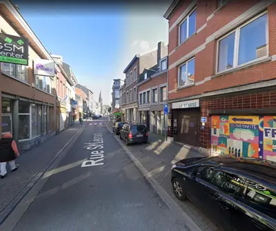 a city street with cars parked on the side of the road at Chambre de luxe RIO a Liège Sale de bain privée check in autonome cuisine partagée in Liège