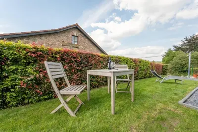 two chairs and a table in a yard at L étage in Soumagne