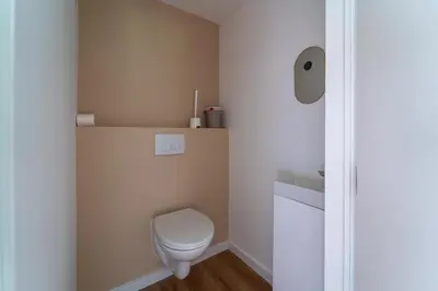 a small bathroom with a toilet and a sink at vakantie-hengelhoef in Houthalen-Helchteren