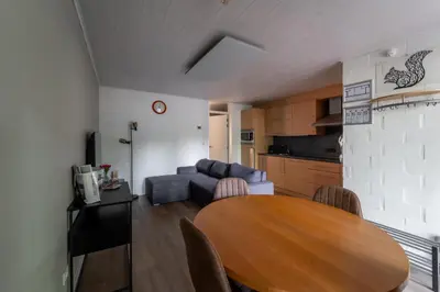 a living room with a table and a couch at vakantie-hengelhoef in Houthalen-Helchteren