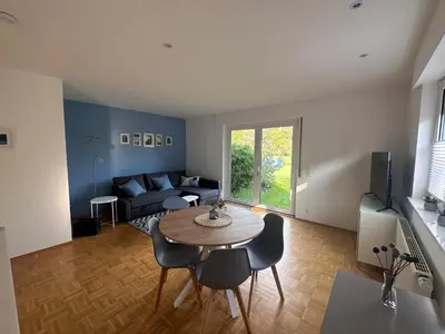 a living room with a table and a couch at Johannisbeere in Raeren