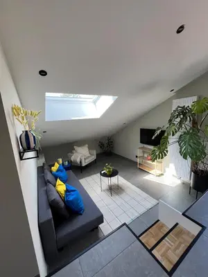 a living room with a couch and a skylight at Studio SC - Cozy appartement in Genk near Thor Park - 4 people in Genk