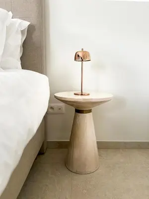 a small table sitting next to a bed at Inspire Residence and private Wellness in Tongeren