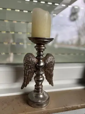 a candle holder with angel wings on a table at Villa les Hauts de Heusy in Verviers