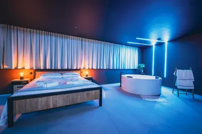 a bedroom with a bed and a bath tub at Suite Soma in Bassenge
