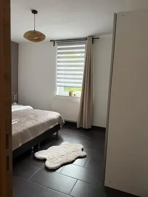a bedroom with a bed and a blanket on the floor at Urban Cocoon in Liège