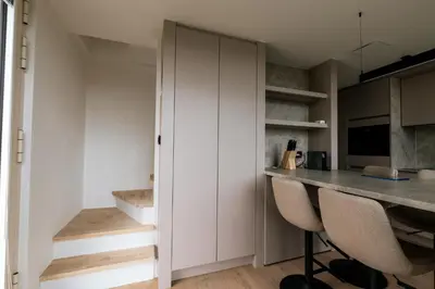 a kitchen with a counter and a desk in a room at Mase waterunits 6 & 7 in Maaseik