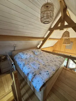 an attic bedroom with a bed in a room at Green Oak House in Dilsen-Stokkem