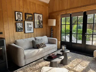 a living room with a couch and a table at Green Oak House in Dilsen-Stokkem