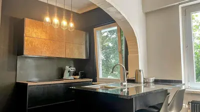 a kitchen with a sink and a counter top at Aux Cèdres - Peaceful stay with easy parking in Liège
