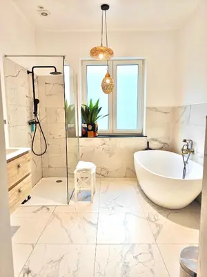 a bathroom with a tub and a shower and a sink at Maison spacieuse, sereine proche du coeur de la ville et de la gare in Liège