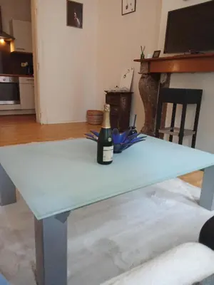 a bottle of wine sitting on top of a blue table at Night in Liège