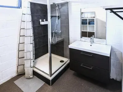a bathroom with a shower and a sink at Farmhouse with garden and wellness in Heers