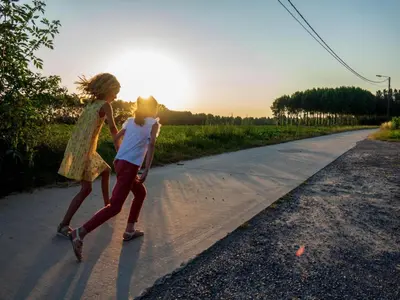 two children are walking down a road at Cozy duplex apartment with terrace in Heers