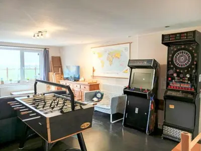 a living room with a game console and a video game at Single-storey holiday home in Heers in Heers